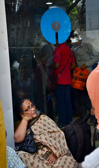 Kolkata: People queue in front of banks, ATMs to get cash
