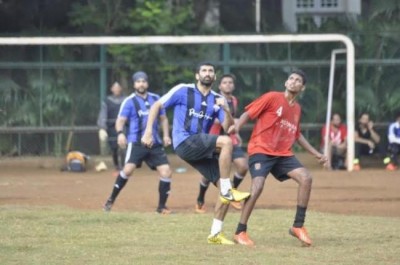 Aditya plays impromptu football with area kids