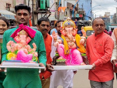 People carry Lord Ganesh to their home on Ganesha Chaturthi