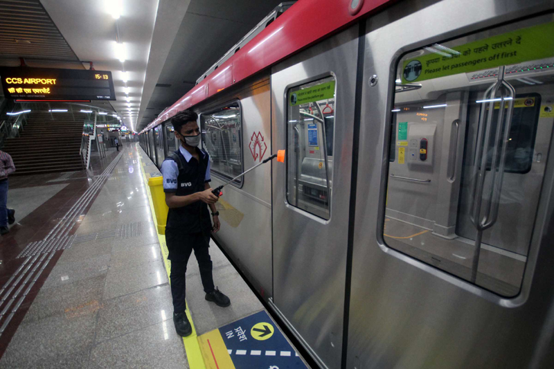 Lucknow Metro employee sprays disinfectants inside coaches at Hazratganj station
