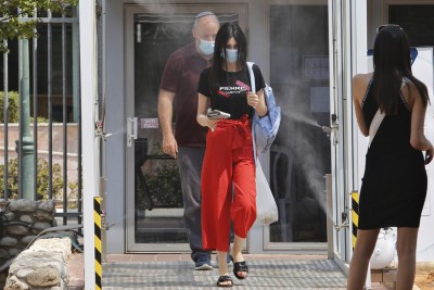 People walk through disinfection tunnel in Israel