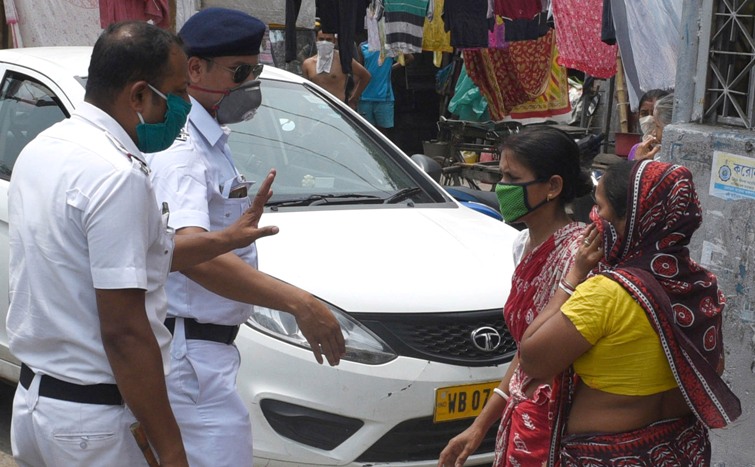 People queue up in front of pharmacies in Kolkata