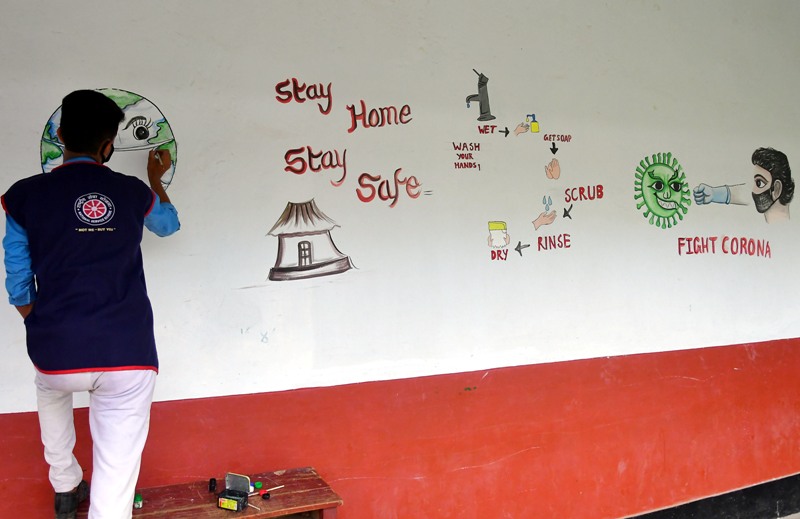 Students create awareness on COVID19 by painting on school wall