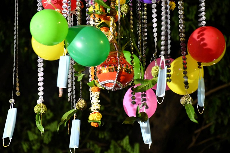 Boy wearing mask breaks earthen pot to mark Janmashtami