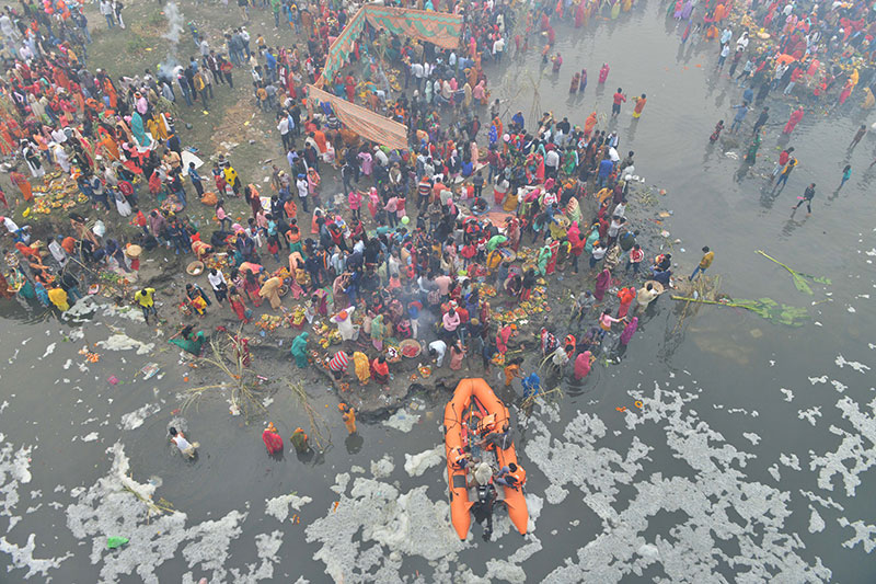 Devotees worship the rising sun at the banks of Yamuna in Delhi