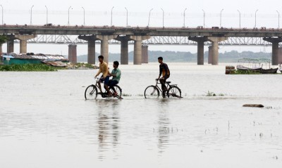 Prayagraj: Boys cycling in the flood water of Ganga