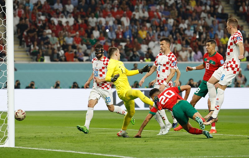 Achraf Dari of Morocco celebrates his goal with teammates during third place play-off match