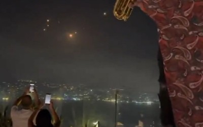 Israel-Iran crisis: Party goers in Lebanon click missiles streaking across night sky while partying in rooftop cafe