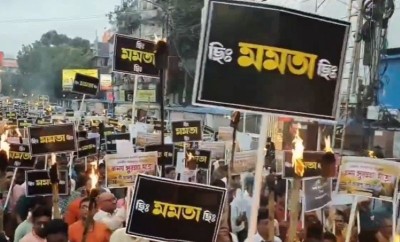 BJP workers participate in a torch rally to protest Kolkata gangrape