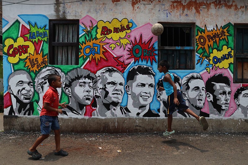 In Images: Children in Kolkata play beneath a giant World Cup masterpiece