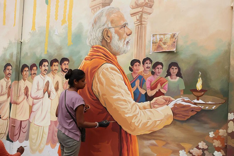 In Images: Kolkata’s Chorebagan Sarbojonin unveils wall painting of PM Modi performing aarti to Goddess Durga