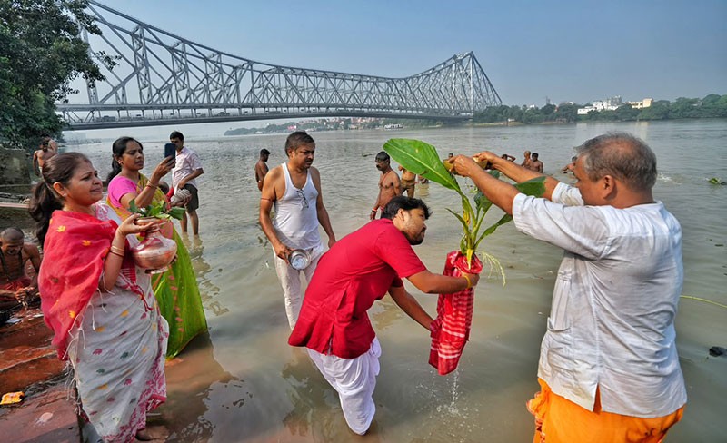 In Images: Kala Bou snan performed at Kolkata ghats on Durga Puja Maha Saptami
